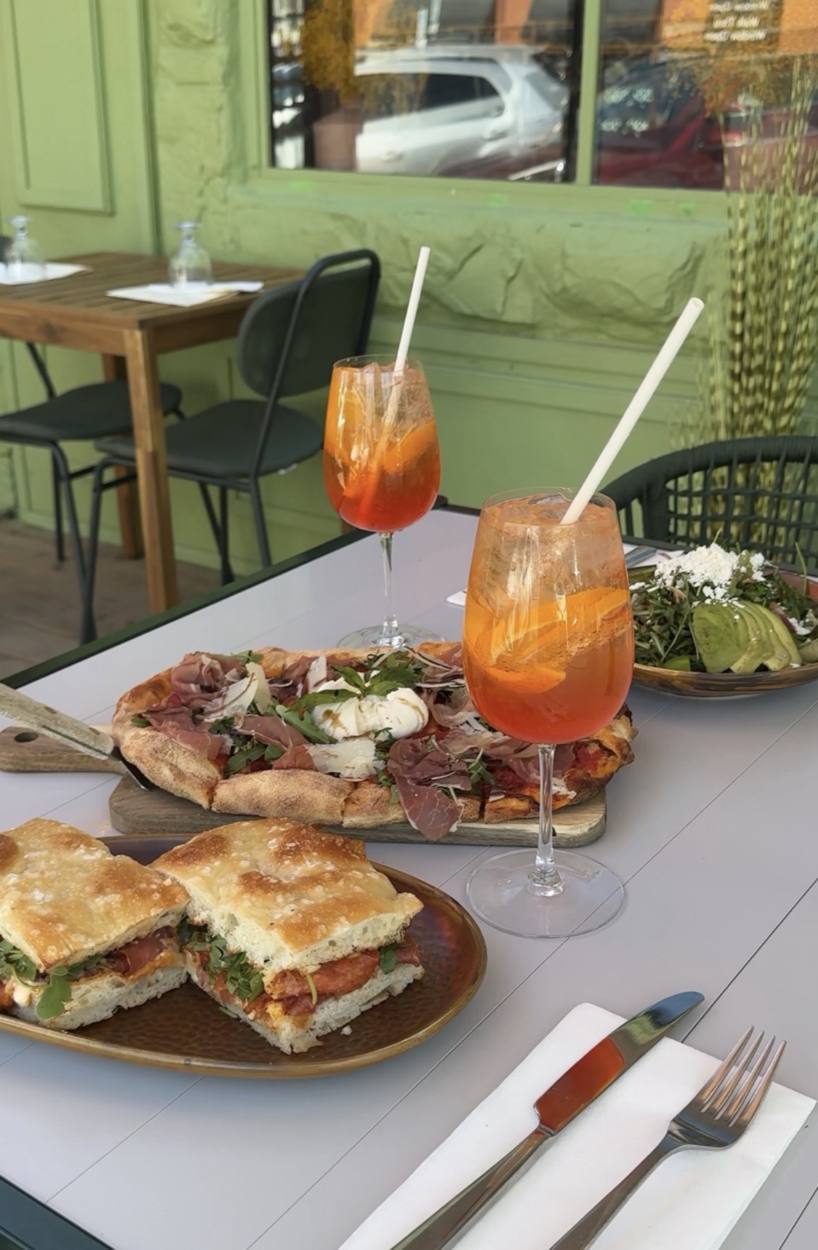Focaccia sandwich with Aperol spritzes on the patio